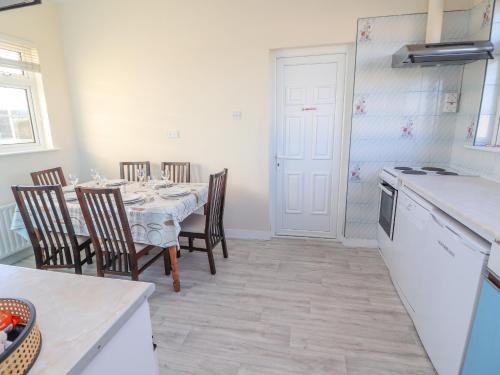 a kitchen and dining room with a table and chairs at Mullagh Road in Miltown Malbay