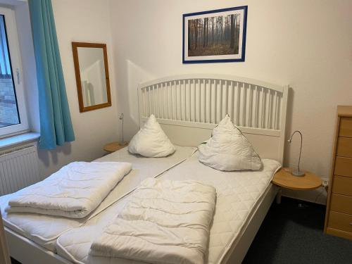 two beds with pillows on them in a bedroom at Seeblick Wohnung 115 in Ostseebad Koserow