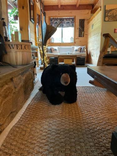 a large stuffed bear sitting on the floor of a store at The Snowed Inn in Killington