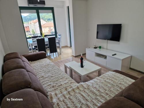 a living room with a couch and a tv at Apartman Paradise Fojnica in Fojnica