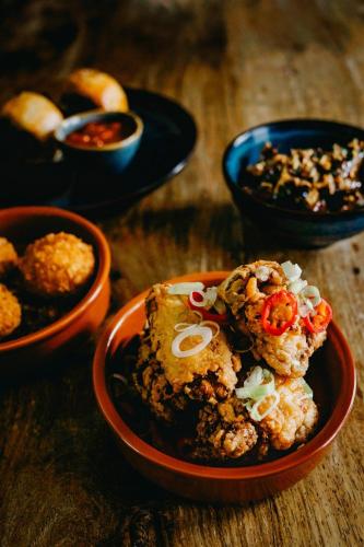 a bowl of food on a table with other bowls of food at Coorie Inn Restaurant and Rooms in Crieff
