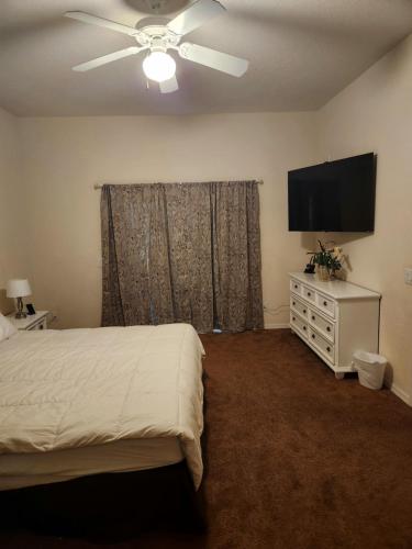 a bedroom with a bed and a flat screen tv at Bahama Bay 116 in Kissimmee