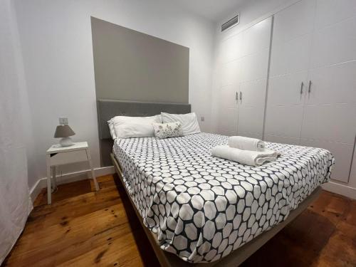 a bedroom with a large bed with white cabinets at Eclectic 2BR with shared terrace perfect getaway in Gibraltar