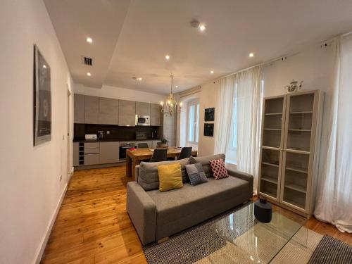 a living room with a couch and a kitchen at Eclectic 2BR with shared terrace perfect getaway in Gibraltar