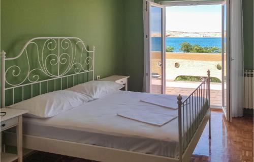 a bedroom with a bed and a view of the ocean at 3 Bedroom Stunning Apartment In Kustici in Kustići