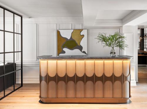 a bar in a room with white walls at Kimpton Brice Hotel by IHG in Savannah