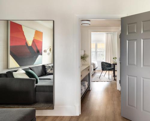 a living room with a couch and a mirror at Kimpton Brice Hotel by IHG in Savannah