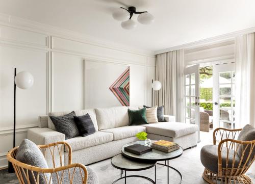a living room with a couch and a table and chairs at Kimpton Brice Hotel by IHG in Savannah