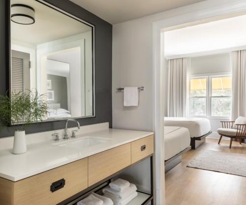 a bathroom with a sink and a mirror at Kimpton Brice Hotel, an IHG Hotel in Savannah