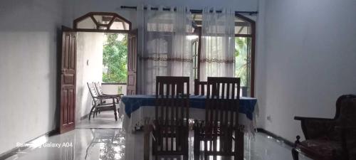 a dining room with chairs and a table and a window at freedom house in Unawatuna