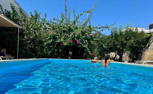 a person sitting in a swimming pool at B&B Don Alessandro in Surbo
