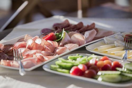 a table topped with trays of different types of food at WURZENBERG Hotel Lodges Südsteiermark in Gamlitz