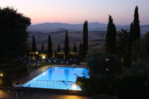 a pool in a villa with a view of the mountains at Casanova - Wellness Center La Grotta Etrusca in San Quirico dʼOrcia