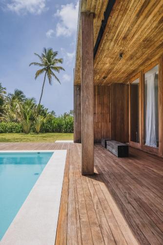 an external view of a house with a swimming pool at KA BRU 1100 Boutique Hotel in Taipu