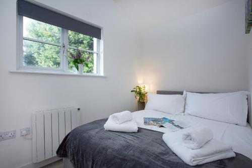 a bedroom with a bed with towels on it at The Hay Loft in Sidmouth