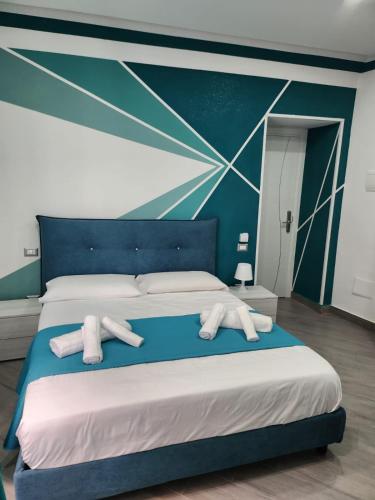 a bedroom with a bed with white towels on it at Gradini Partenopei in Naples