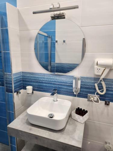 a bathroom with a sink and a mirror at Gradini Partenopei in Naples