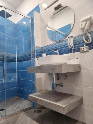 a bathroom with a sink and a mirror at Gradini Partenopei in Naples