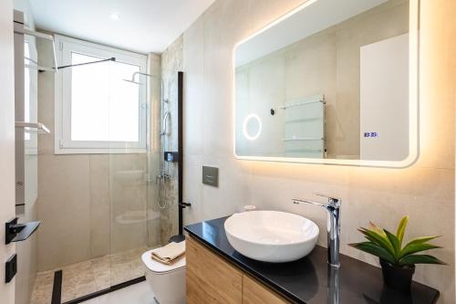 a bathroom with a sink and a toilet and a mirror at Yin & Yang Studio, Marina Hideout in Kalamata (B3) in Kalamata