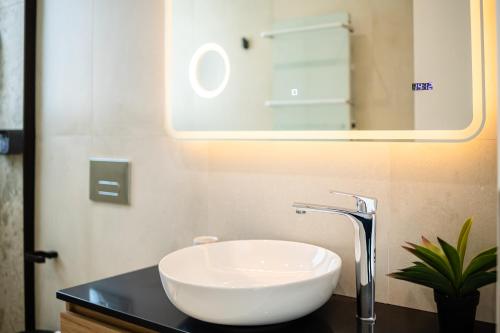 a bathroom with a white sink and a mirror at Yin & Yang Studio, Marina Hideout in Kalamata (B3) in Kalamata