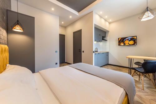 a bedroom with a large white bed and a table at DayFlat Apartments Maidan Area in Kyiv