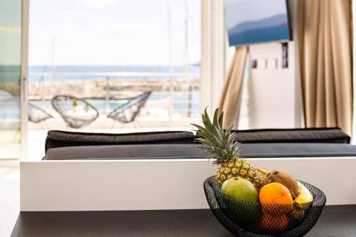 a bowl of fruit on a table in front of a window at Yin & Yang Studio, Marina Hideout in Kalamata (B3) in Kalamata