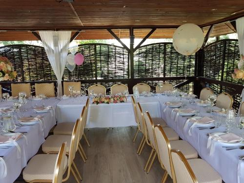 - une grande table avec des tables et des chaises blanches dans la chambre dans l'établissement Albert Turystyczne Usługi Hotelarskie, à Varsovie