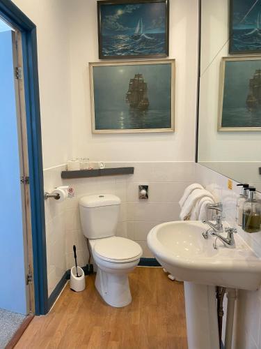 a bathroom with a toilet and a sink at Knights Court in Great Yarmouth