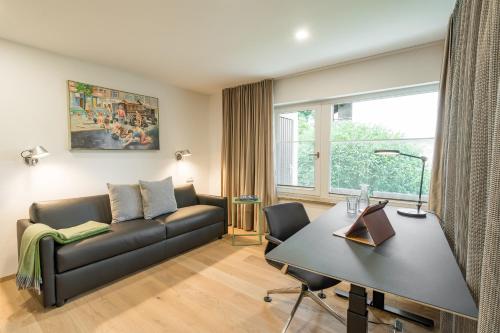 a living room with a couch and a table at Edelbude in Oberstdorf