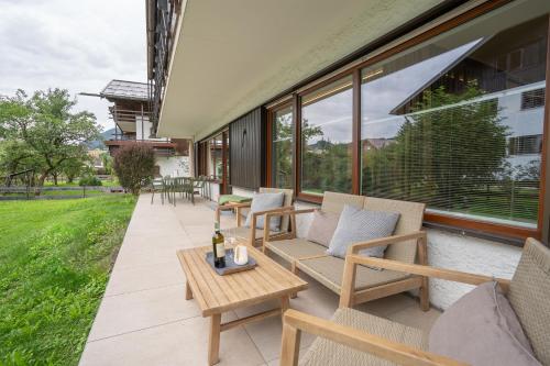 a patio with chairs and a table and some windows at Edelbude in Oberstdorf