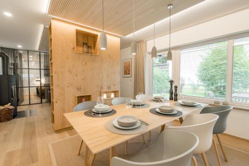a dining room with a wooden table and chairs at Edelbude in Oberstdorf