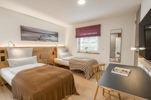 ein Schlafzimmer mit einem Bett, einem Tisch und einem Sofa in der Unterkunft Edelbude in Oberstdorf