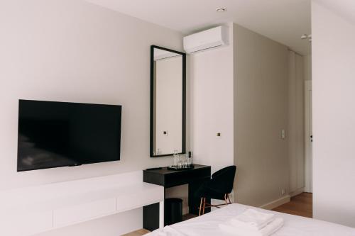 a bedroom with a bed and a tv on a wall at Anaberg in Nowa Ruda