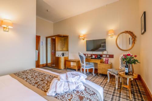 a hotel room with a bed and a desk at Muthu Alexandra Hotel in Oban