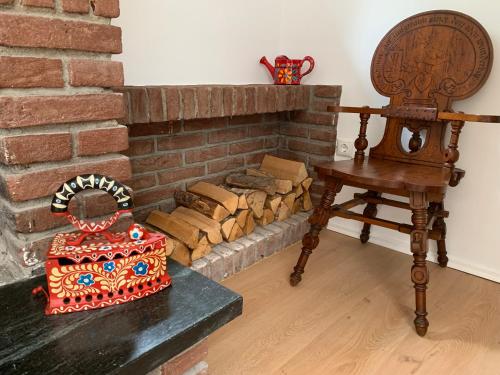 a table and a chair next to a brick fireplace at Spacious house for large groups and families in Würzburg