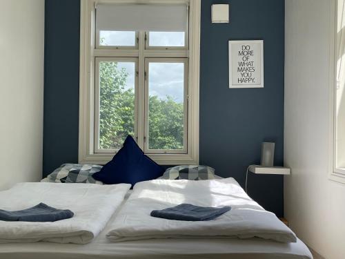 a bedroom with a bed with two pillows on it at Central Nicolas Apartment Nr6 Stavanger 4 rooms in Stavanger