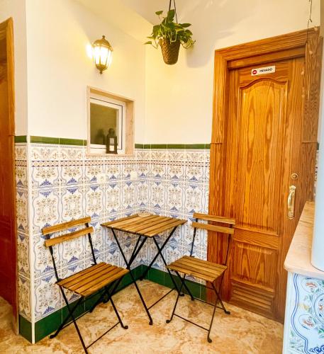 two chairs sitting at a bar in a room at Casa junto al Mar in El Ejido