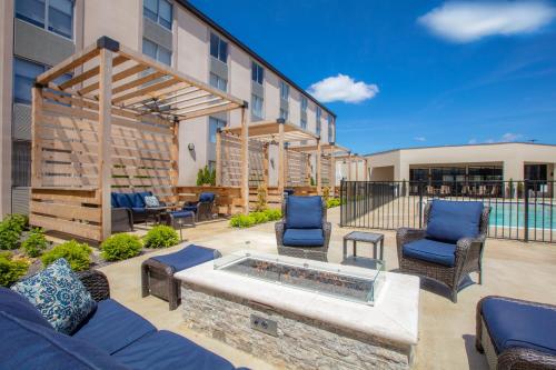a patio with chairs and a fire pit at Holiday Inn St Louis SW - Route 66 by IHG in Saint Louis