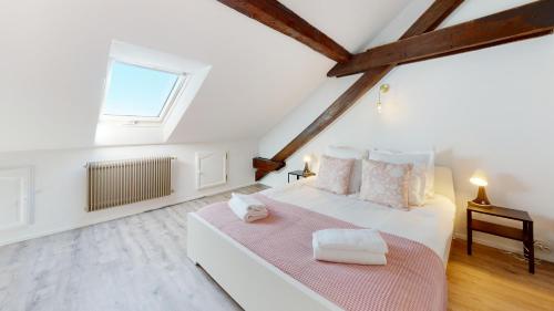 une chambre blanche avec un grand lit et une fenêtre dans l'établissement Le Cocon Colmarien - Proche centre ville et gare - stationnement gratuit - 10 personnes, à Colmar