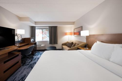 a hotel room with a large bed and a television at Fairfield Inn Boston Tewksbury/Andover in Tewksbury