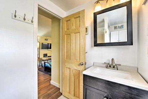 a bathroom with a sink and a mirror at The Starfish Hampton Cottage Walk to Beach! in Hampton