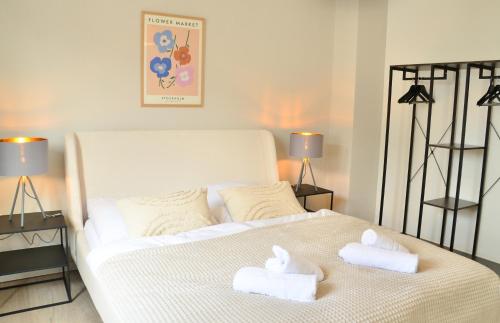 a white bed with two towels on top of it at MILPAU Bottrop 2 - Modernes und zentrales Premium-Apartment für 4 Personen mit Queensize-Bett und Einzelbetten - Netflix, Nespresso und Smart-TV in Bottrop