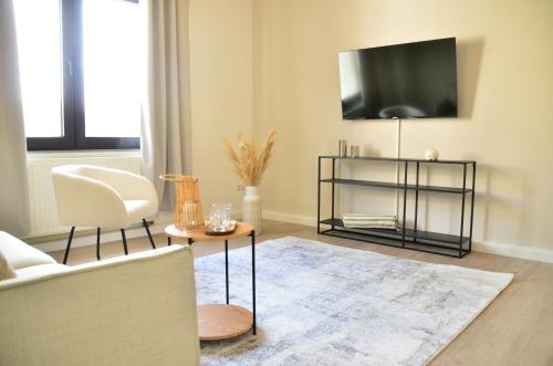 En TV eller et underholdningssystem på MILPAU Bottrop 2 - Modernes und zentrales Premium-Apartment für 4 Personen mit Queensize-Bett und Einzelbetten - Netflix, Nespresso und Smart-TV