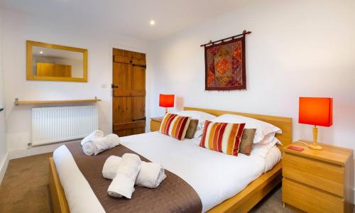 a bedroom with a bed with towels on it at The Mistal in Newby Bridge