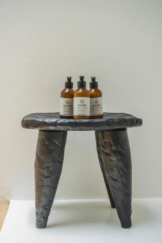 three bottles of whiskey sitting on a bench at KA BRU 1100 Boutique Hotel in Taipu