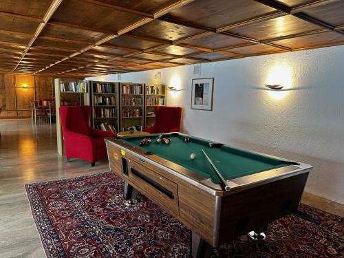 a room with a pool table in a room at Appartementhaus Birkenwald in Seefeld in Tirol