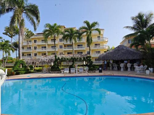 a large swimming pool in front of a hotel at DulceVilla_en la playa in Boca Chica