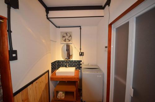 a small bathroom with a sink and a toilet at GRANDPA'S HOUSE Barchanchi - Vacation STAY 53569v in Naha