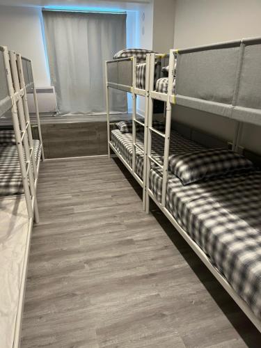 a row of bunk beds in a room at Hotel Bon Accueil in Montréal