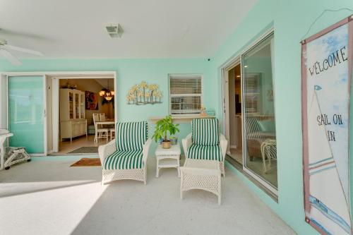 a living room with two chairs and a table at Venice Vacation Rental with Private Outdoor Pool! in Venice